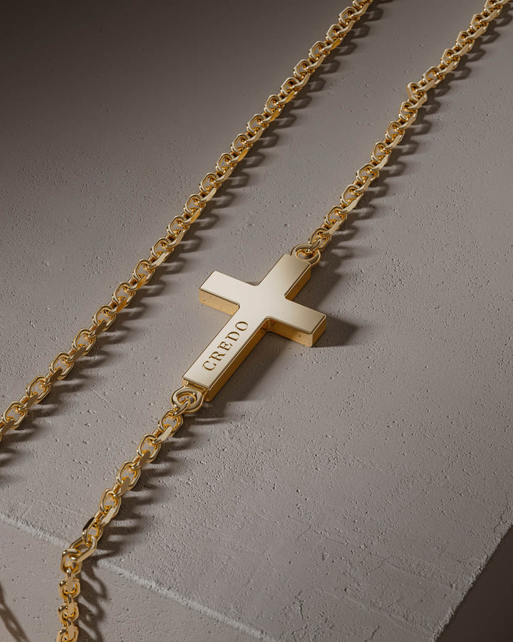Gold side cross with CREDO engraving, close-up