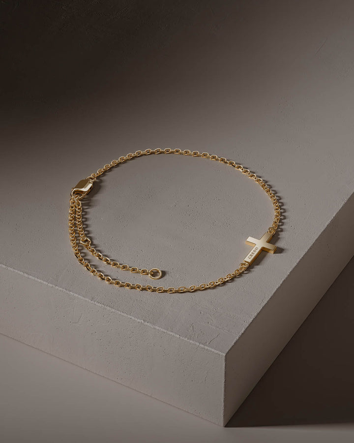 Side cross bracelet in gold with adjustable chain, full view
