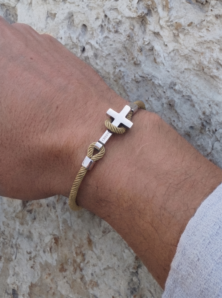 Men's Rope Cross Bracelet in khaki with a silver cross, lifestyle view