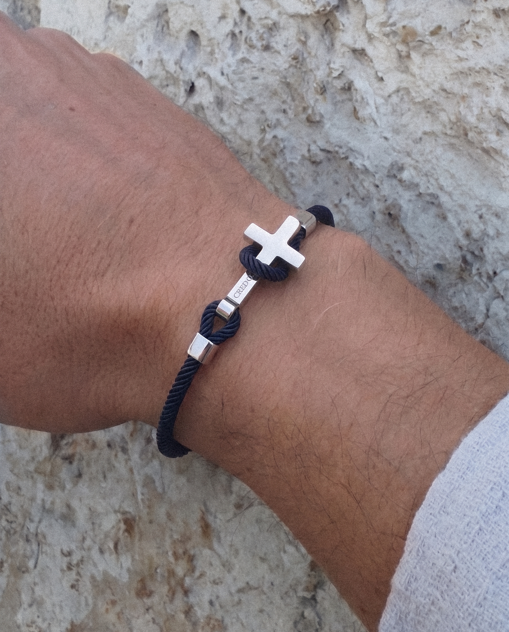 Men's Rope Cross Bracelet in navy blue with a silver cross, lifestyle view